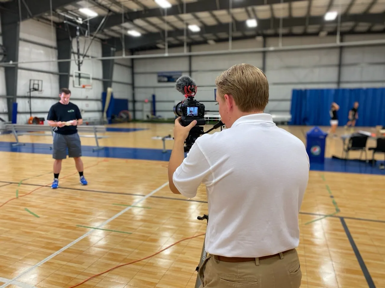 Filming an athlete on an indoor basketball court